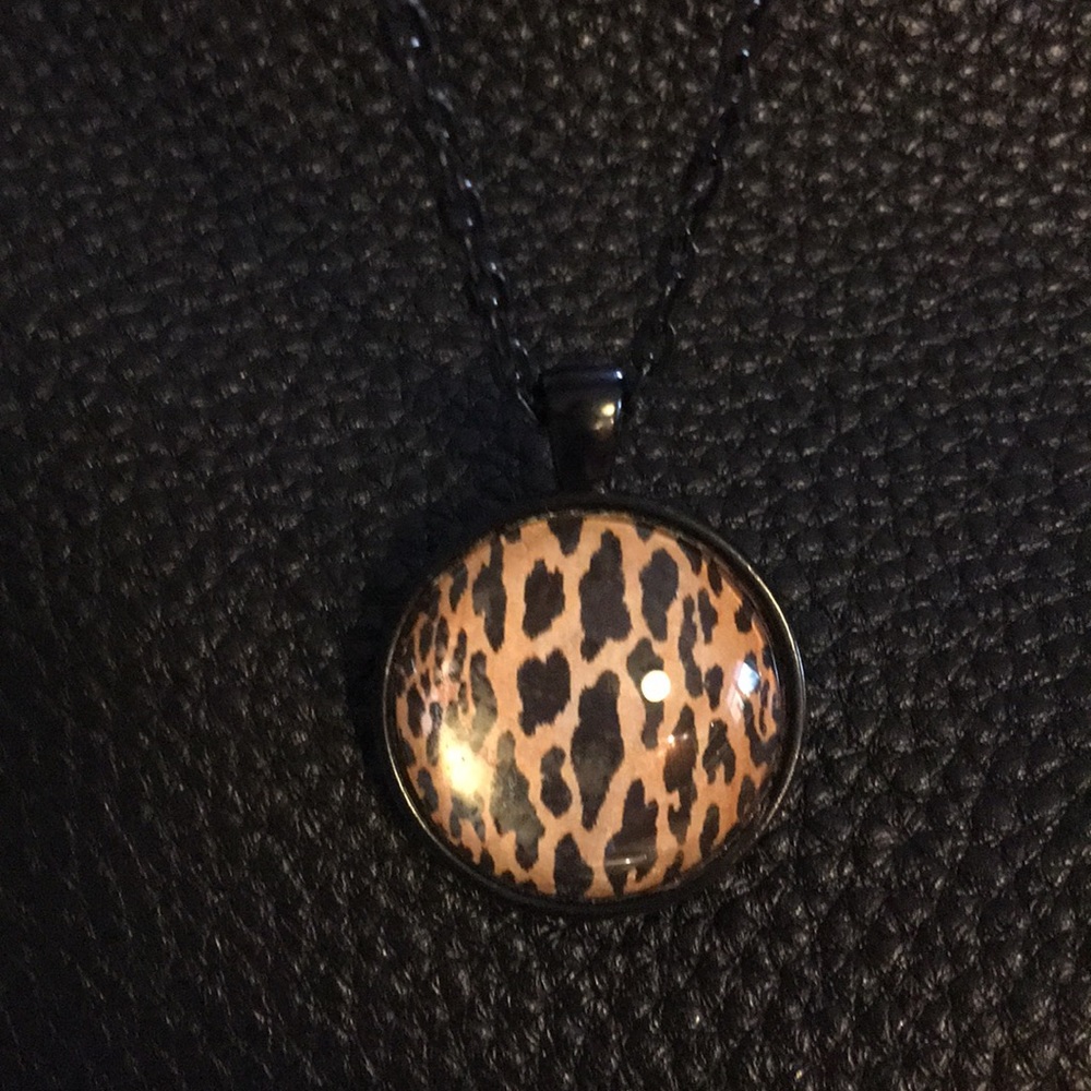 Animal print pendant on black chain